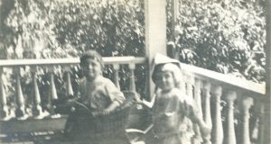 Nina Winn's Niece and Nephew play on the porch of their nearby home. Click on image to view in closer detail.