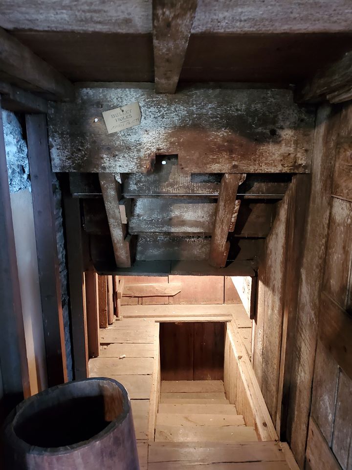 A new hole found near kitchen stairs. This hole was hidden
when new molding was attached to the stairs leading into the
cellar. It can be viewed only by looking along the wall on the
reverse side with a flashlight.